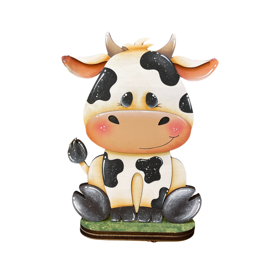 (Copia) Mucca seduta con fiori Out of the Wood
