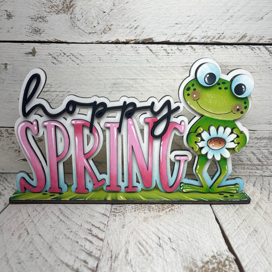 Scritta Hoppy spring Out of the Wood