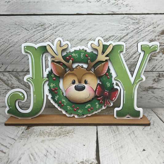 Scritta “Joy” rudolf Out of the Wood