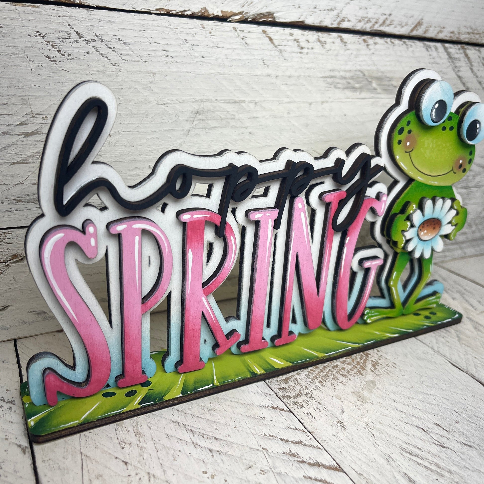 Scritta Hoppy spring Out of the Wood